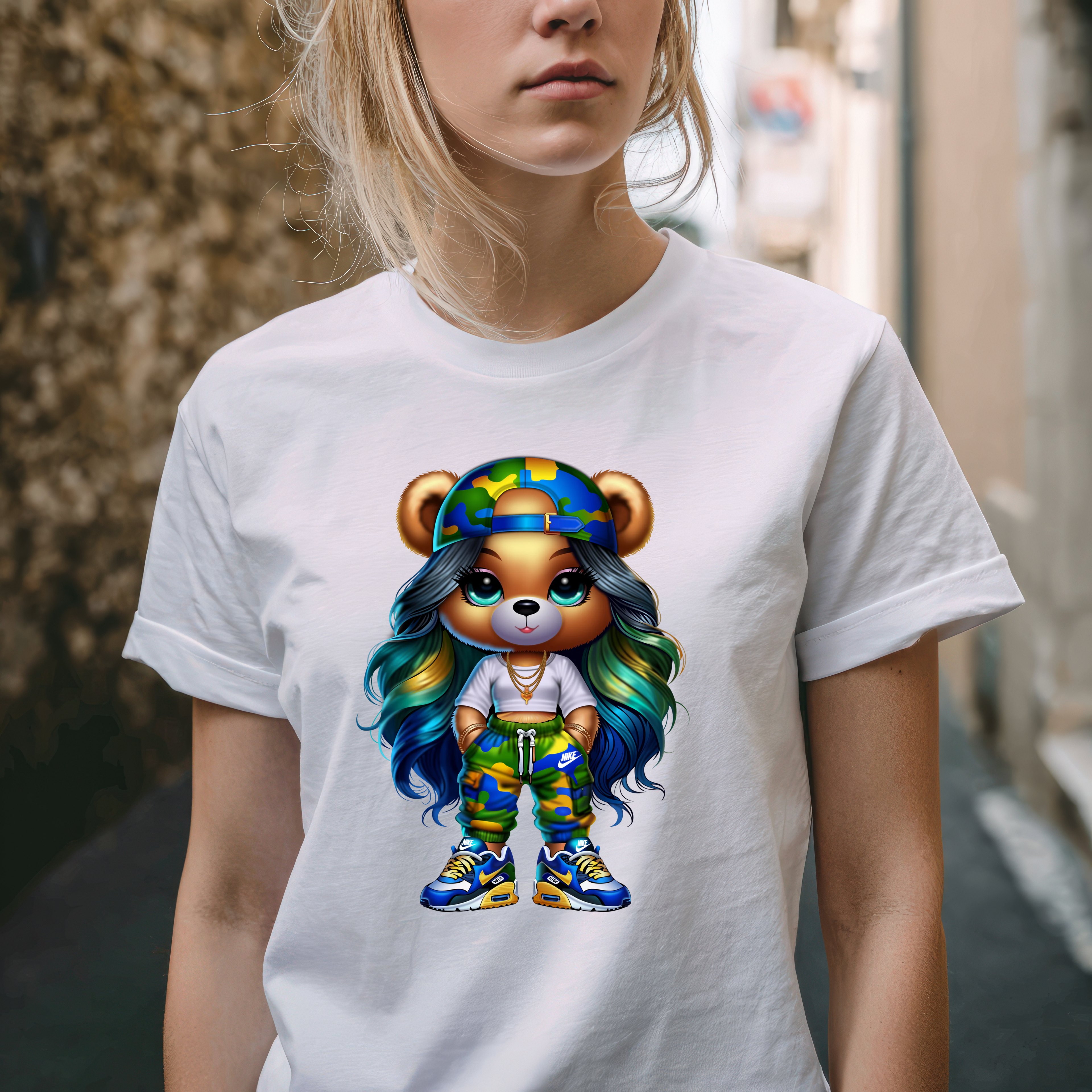 Person wearing a white t-shirt with a colorful bear graphic design.